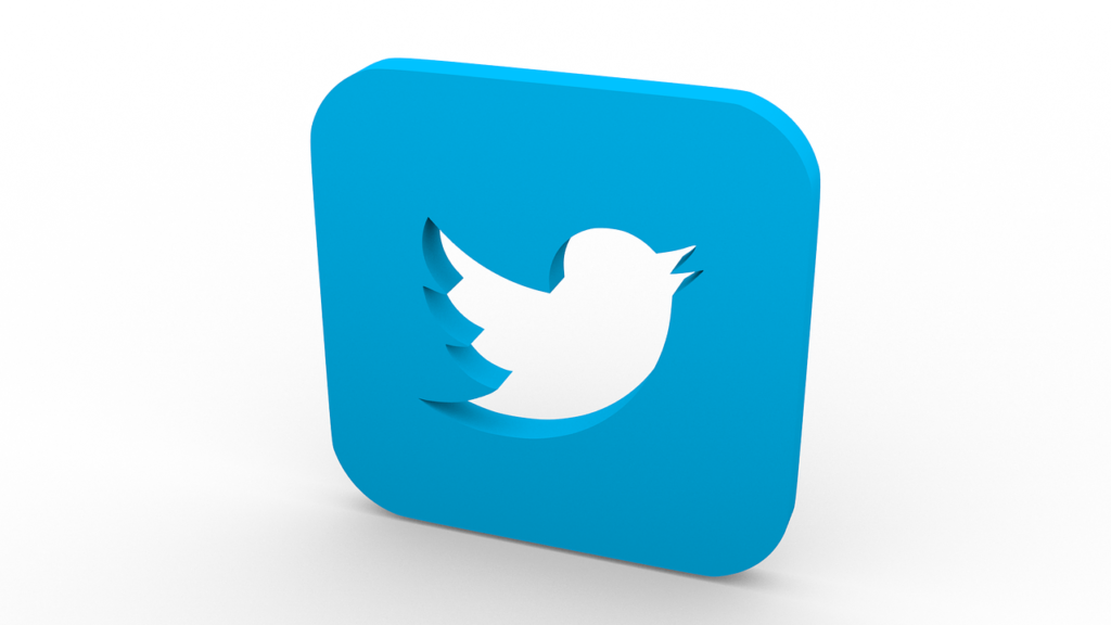 Une icône carrée arrondie en trois dimensions avec un fond bleu et une silhouette d'oiseau blanc au centre, représentant le logo Twitter.